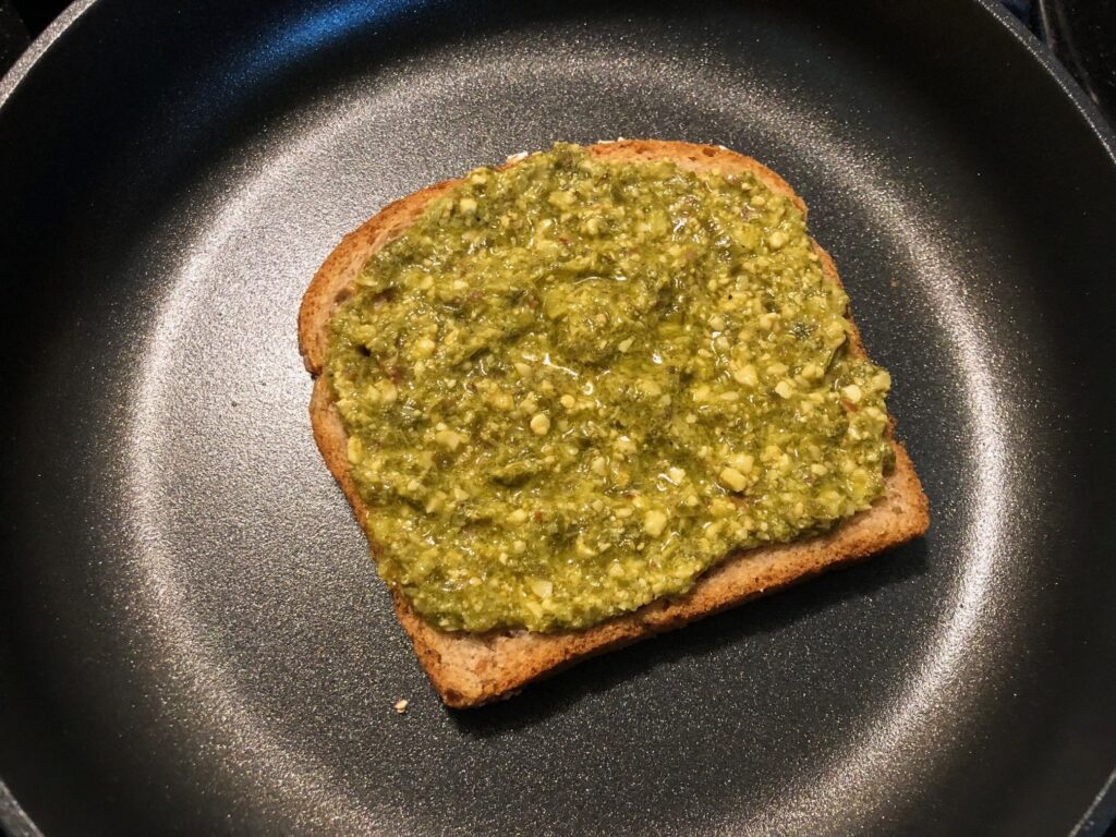 Spread pesto on the first slice of bread
