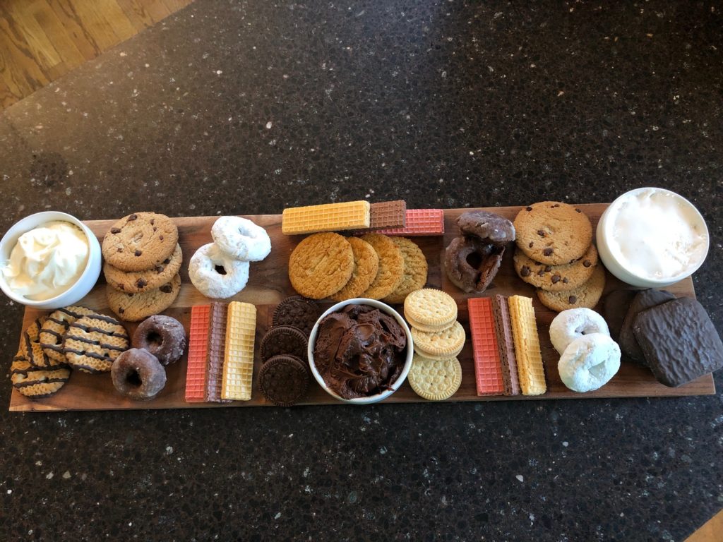 Adding the cookies and donuts to the Galentine's Day Treat Board